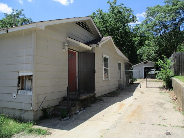 1001 Park St, North Little Rock, AR 72114 - view of home's exterior featuring entry steps, concrete driveway, and a gate