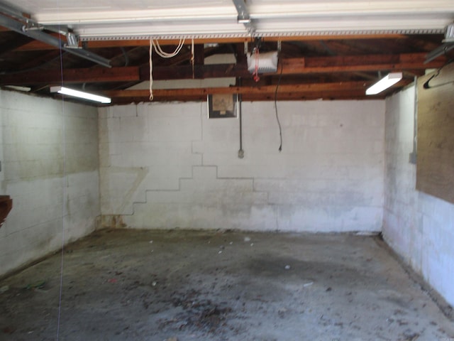 1001 Park St, North Little Rock, AR 72114 - garage with a garage door opener and concrete block wall