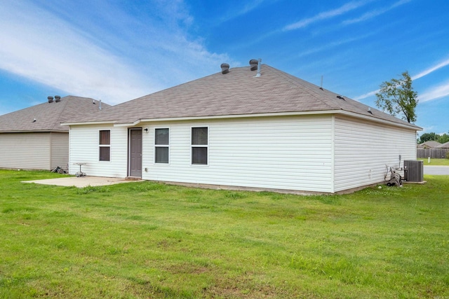 6637 Trammel Estates Ln, North Little Rock, AR 72117 - rear view of house featuring a patio area, central AC unit, a lawn, and a shingled roof