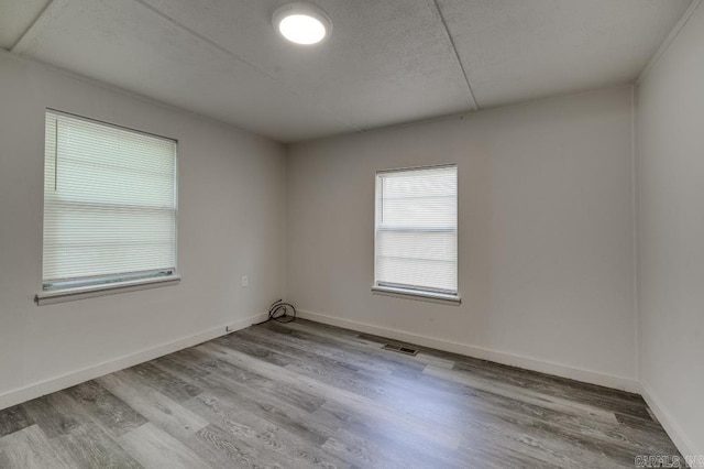 208 King Rd, Benton, AR 72019 - empty room featuring wood finished floors, baseboards, and a textured ceiling