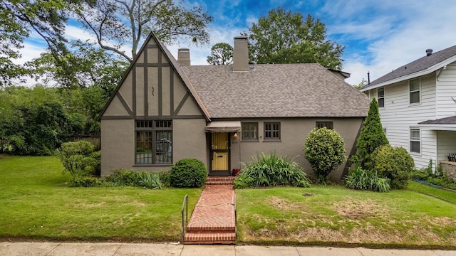 489 Ridgeway Dr, Little Rock, AR 72205 - tudor home with stucco siding, a shingled roof, a front yard, and a chimney