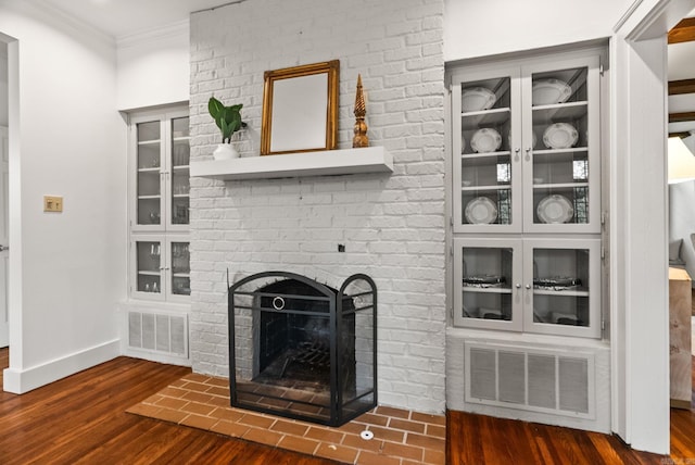489 Ridgeway Dr, Little Rock, AR 72205 - unfurnished living room with wood finished floors, crown molding, baseboards, and a fireplace