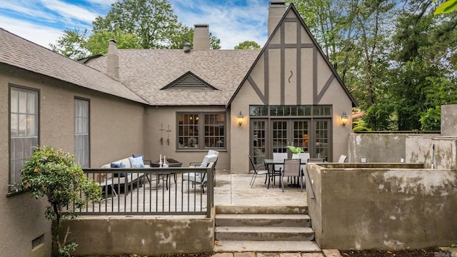 489 Ridgeway Dr, Little Rock, AR 72205 - rear view of house with a patio, roof with shingles, stucco siding, and outdoor dining space