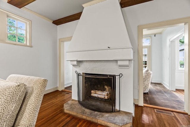 489 Ridgeway Dr, Little Rock, AR 72205 - detailed view of a fireplace with raised hearth, wood finished floors, baseboards, and ornamental molding