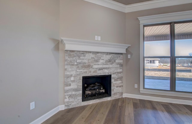 69 Lucia Ln, Maumelle, AR 72113 - unfurnished living room with a stone fireplace, baseboards, wood finished floors, and crown molding