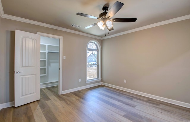 69 Lucia Ln, Maumelle, AR 72113 - empty room with a ceiling fan, baseboards, wood finished floors, and ornamental molding