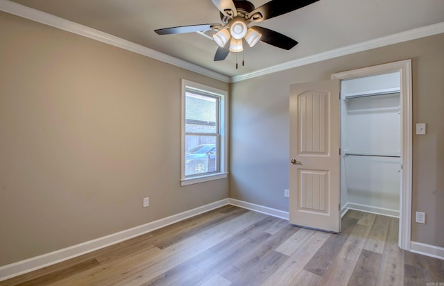 69 Lucia Ln, Maumelle, AR 72113 - unfurnished bedroom featuring light wood finished floors, baseboards, ornamental molding, a spacious closet, and a closet
