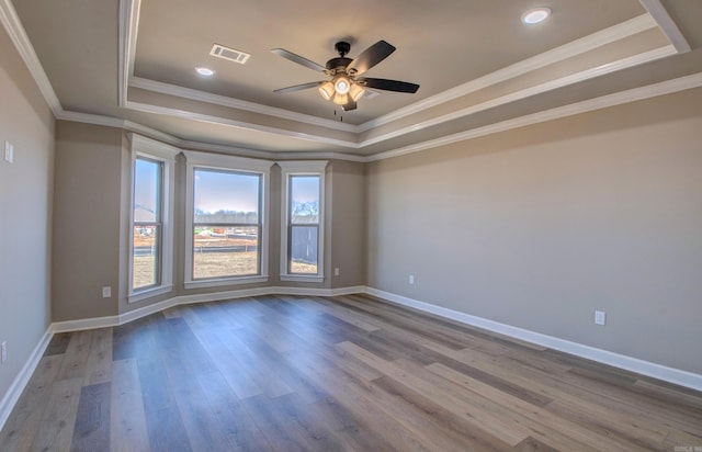 69 Lucia Ln, Maumelle, AR 72113 - empty room featuring a tray ceiling, ceiling fan, wood finished floors, baseboards, and crown molding