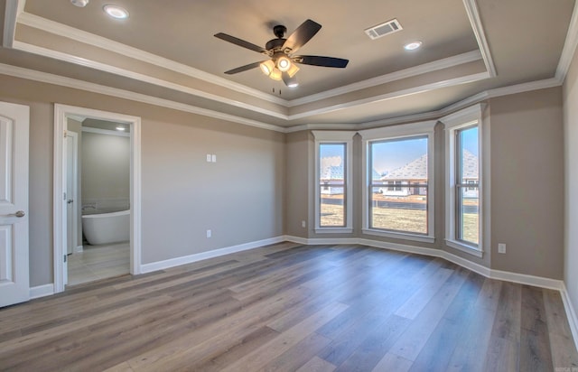 69 Lucia Ln, Maumelle, AR 72113 - empty room featuring a tray ceiling, baseboards, ceiling fan, wood finished floors, and crown molding