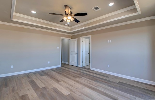 69 Lucia Ln, Maumelle, AR 72113 - empty room with a raised ceiling, a ceiling fan, baseboards, ornamental molding, and light wood-style flooring