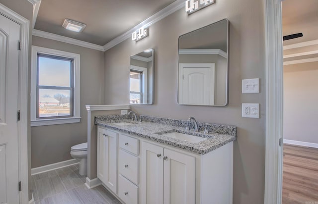 69 Lucia Ln, Maumelle, AR 72113 - full bath featuring baseboards, double vanity, toilet, and ornamental molding