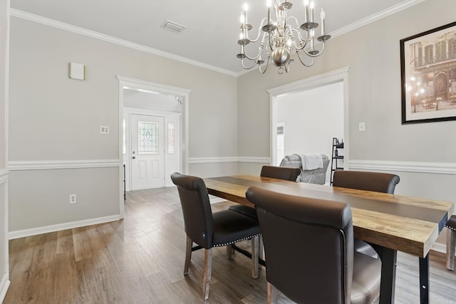 11 Crystal Mountain Ln, Maumelle, AR 72113 - dining room featuring a chandelier, wood finished floors, ornamental molding, and baseboards