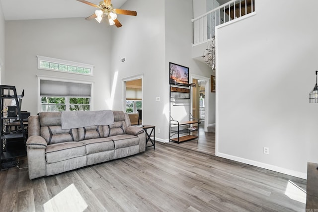 11 Crystal Mountain Ln, Maumelle, AR 72113 - living area featuring ceiling fan, high vaulted ceiling, wood finished floors, and baseboards