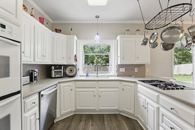 11 Crystal Mountain Ln, Maumelle, AR 72113 - kitchen with appliances with stainless steel finishes, white cabinets, a sink, light countertops, and dark wood-style floors