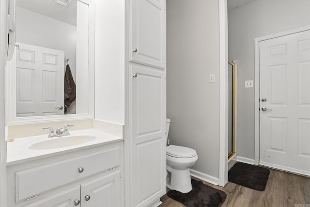 11 Crystal Mountain Ln, Maumelle, AR 72113 - full bath with toilet, vanity, wood finished floors, a stall shower, and baseboards
