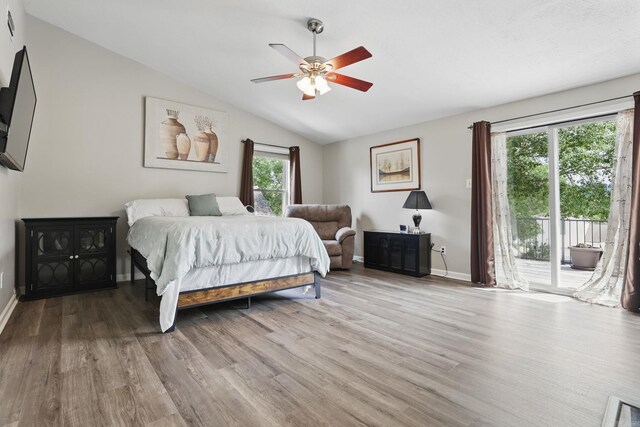 11 Crystal Mountain Ln, Maumelle, AR 72113 - bedroom featuring access to outside, multiple windows, wood finished floors, vaulted ceiling, and baseboards