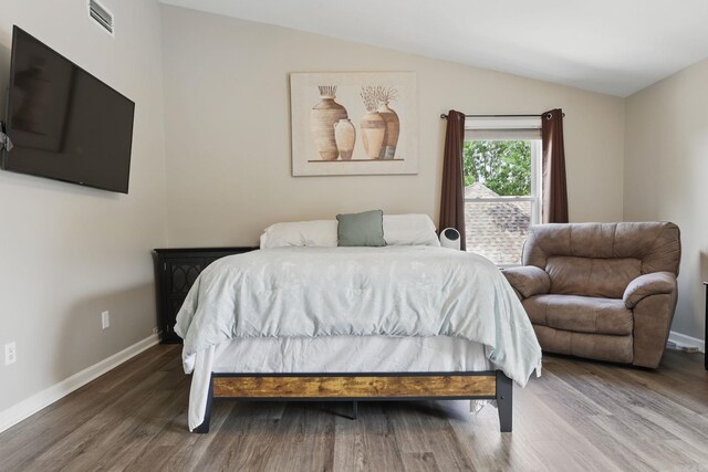 11 Crystal Mountain Ln, Maumelle, AR 72113 - bedroom featuring lofted ceiling, wood finished floors, and baseboards