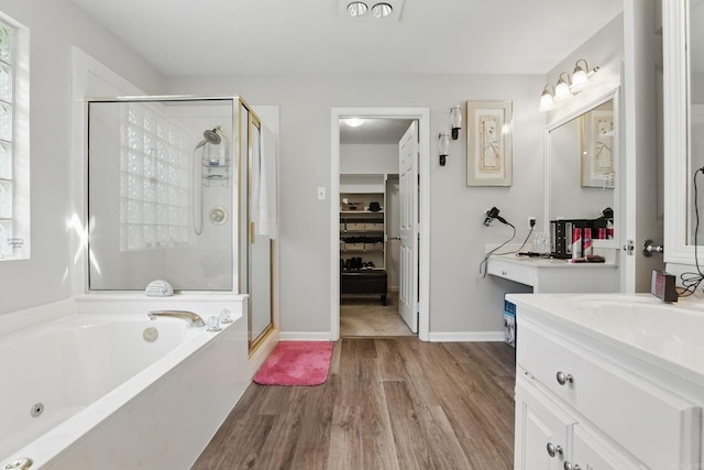 11 Crystal Mountain Ln, Maumelle, AR 72113 - full bathroom with a stall shower, vanity, a tub with jets, wood finished floors, and baseboards
