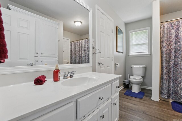 11 Crystal Mountain Ln, Maumelle, AR 72113 - bathroom with vanity, toilet, wood finished floors, baseboards, and a shower with curtain