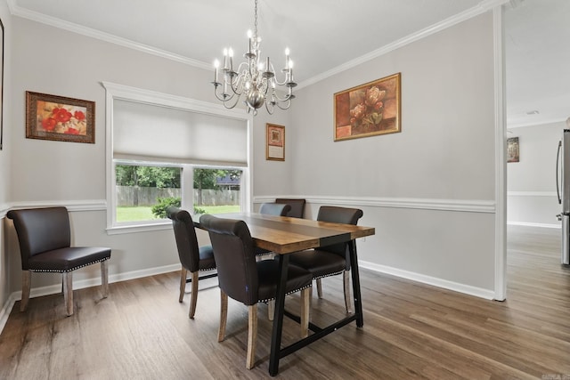 11 Crystal Mountain Ln, Maumelle, AR 72113 - dining area featuring a chandelier, crown molding, wood finished floors, and baseboards
