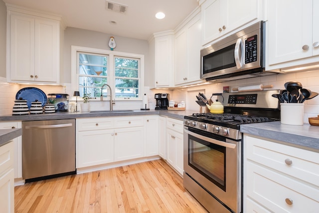 6709 Waverly Dr, Little Rock, AR 72207 - kitchen featuring appliances with stainless steel finishes, a sink, decorative backsplash, and recessed lighting