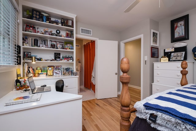6709 Waverly Dr, Little Rock, AR 72207 - bedroom with light wood-style floors, a desk, a ceiling fan, and baseboards