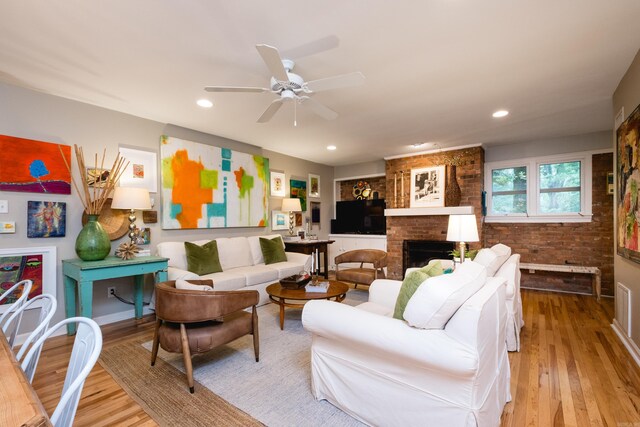 6709 Waverly Dr, Little Rock, AR 72207 - living room with wood finished floors, ceiling fan, a brick fireplace, and recessed lighting