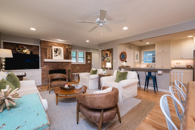 6709 Waverly Dr, Little Rock, AR 72207 - living room with light wood-type flooring, recessed lighting, a brick fireplace, and a ceiling fan