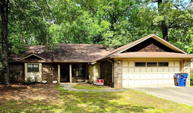 7 Yazoo Cv, Maumelle, AR 72113 - ranch-style house with an attached garage, driveway, brick siding, and roof with shingles