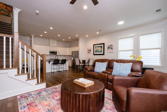 313 Parker St, North Little Rock, AR 72114 - living area with crown molding, dark wood-type flooring, ceiling fan, stairs, and recessed lighting