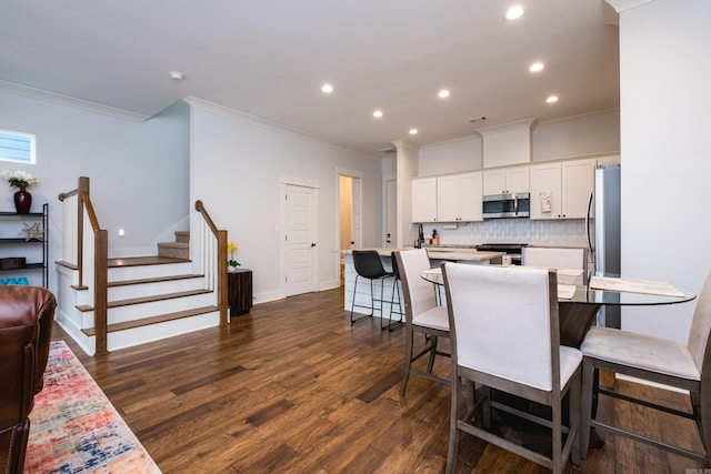 313 Parker St, North Little Rock, AR 72114 - dining room featuring ornamental molding, recessed lighting, dark wood-style flooring, stairway, and baseboards