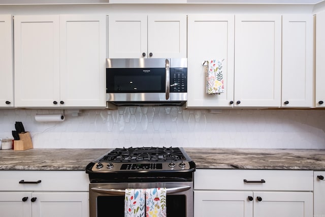 313 Parker St, North Little Rock, AR 72114 - kitchen featuring stainless steel appliances, decorative backsplash, and white cabinets