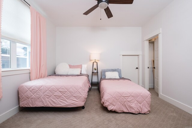 313 Parker St, North Little Rock, AR 72114 - bedroom with carpet flooring, baseboards, and ceiling fan
