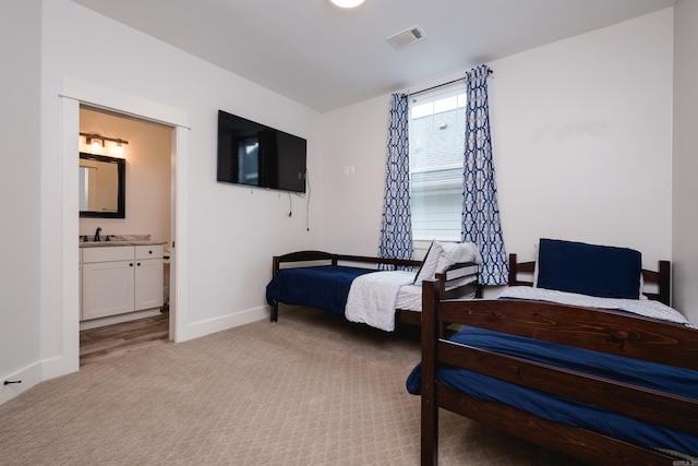 313 Parker St, North Little Rock, AR 72114 - bedroom featuring light colored carpet, a sink, baseboards, and ensuite bathroom