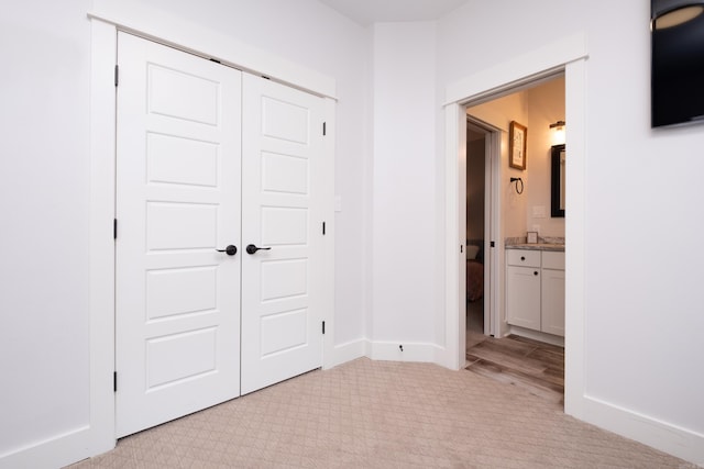 313 Parker St, North Little Rock, AR 72114 - unfurnished bedroom with light carpet, a closet, ensuite bath, and baseboards