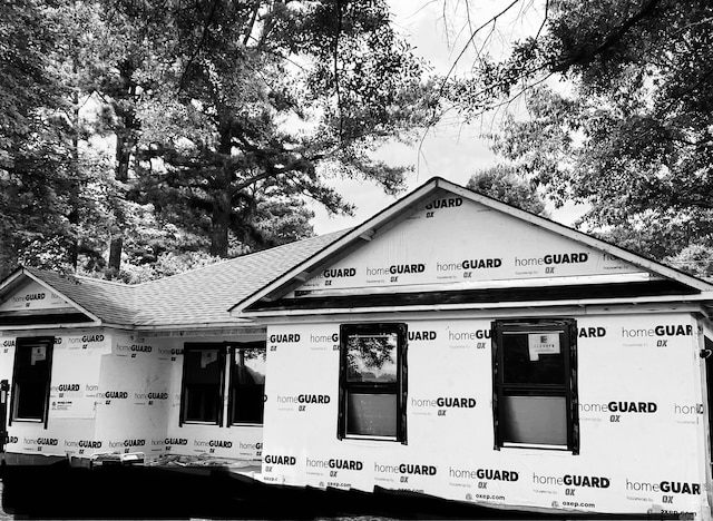 property under construction featuring roof with shingles