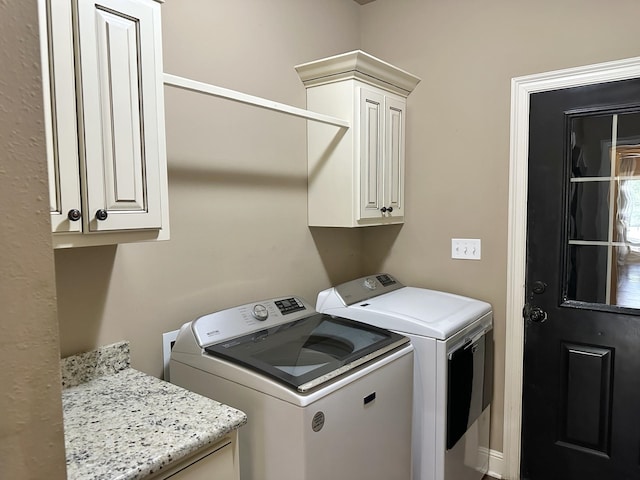 laundry room featuring cabinet space and washer and dryer