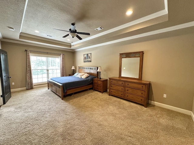 carpeted bedroom featuring a raised ceiling, crown molding, baseboards, a textured ceiling, and ceiling fan