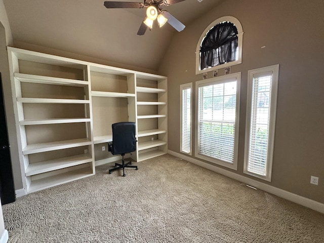 unfurnished office with carpet floors, ceiling fan, vaulted ceiling, and baseboards