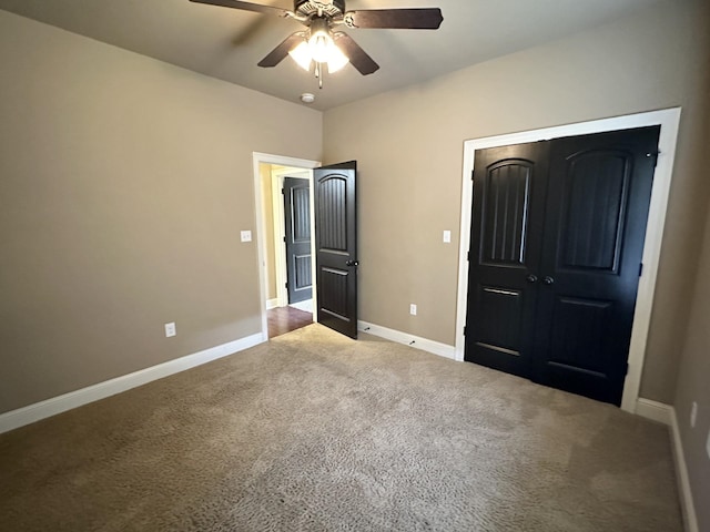 unfurnished bedroom with carpet flooring, baseboards, and ceiling fan