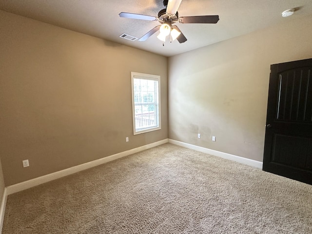 empty room featuring carpet, a ceiling fan, and baseboards