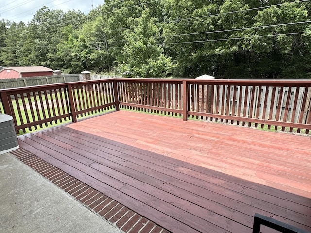 wooden terrace with a fenced backyard