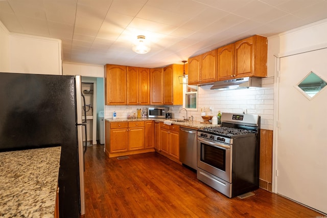 10111 Kling Rd, Mabelvale, AR 72103 - kitchen featuring stainless steel appliances, under cabinet range hood, dark wood-style flooring, light stone counters, and crown molding