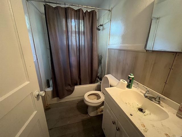 full bathroom featuring shower / bath combo, toilet, vanity, wainscoting, and wood finished floors