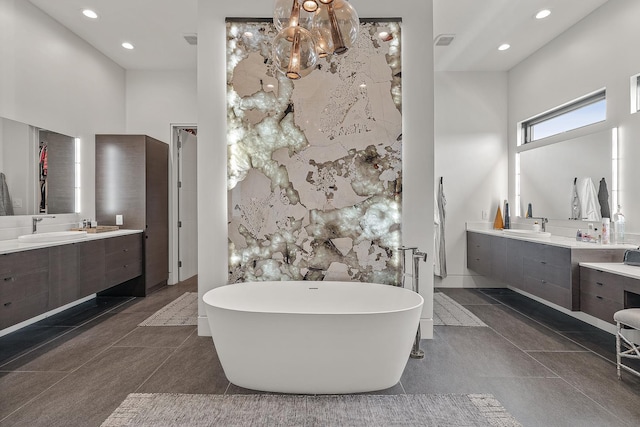 3307 Pruetts Chapel Rd, Paragould, AR 72450 - bathroom with a soaking tub, two vanities, recessed lighting, and a towering ceiling