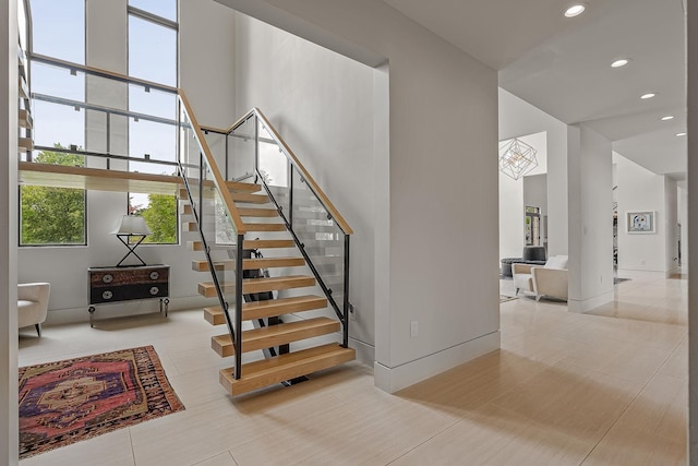 3307 Pruetts Chapel Rd, Paragould, AR 72450 - stairs with a towering ceiling, recessed lighting, tile patterned floors, and baseboards