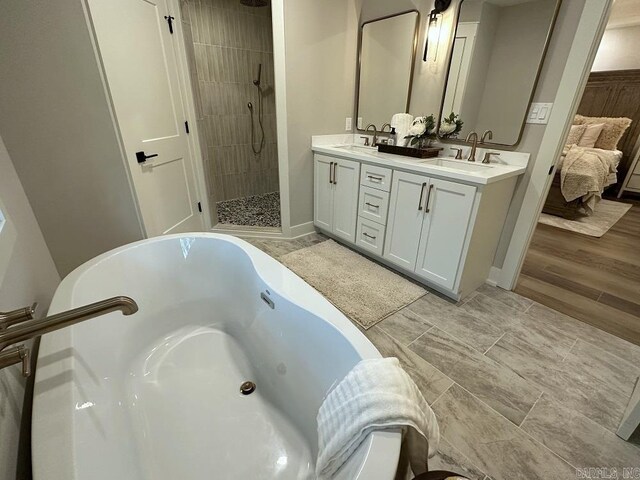 2529 Brandy Dr, Heber Springs, AR 72543 - bathroom with a whirlpool tub, double vanity, tiled shower, and baseboards