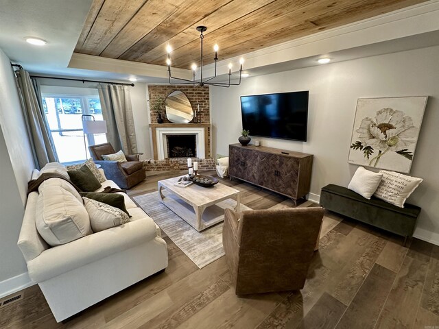 2529 Brandy Dr, Heber Springs, AR 72543 - living room featuring wooden ceiling, wood finished floors, a raised ceiling, baseboards, and a fireplace