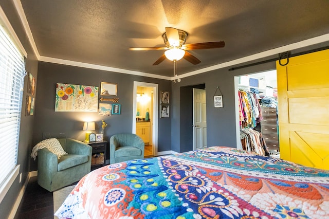 6005 Eagle Creek Rd, North Little Rock, AR 72116 - bedroom with baseboards, a walk in closet, a closet, ensuite bathroom, and wood finished floors