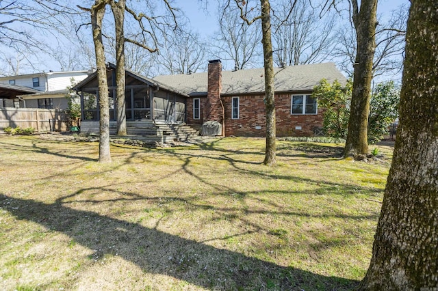 6005 Eagle Creek Rd, North Little Rock, AR 72116 - back of property with a sunroom, a chimney, brick siding, and a shingled roof